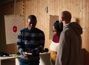 firing-range-expert-welcoming-clients-doing-hand-shake